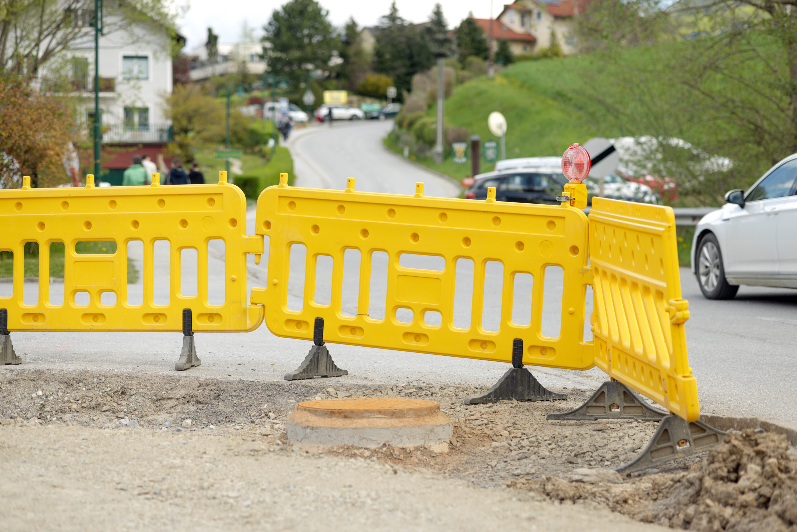 A plastic yellow barrier fence on the street. Road works